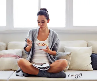 woman eating a bowl of muesli