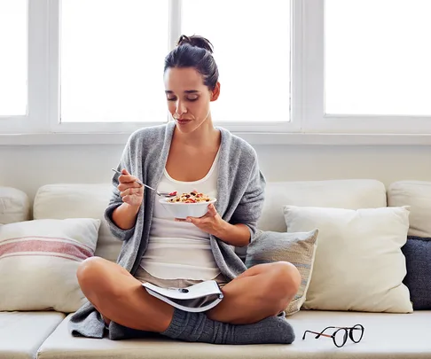 woman eating a bowl of muesli