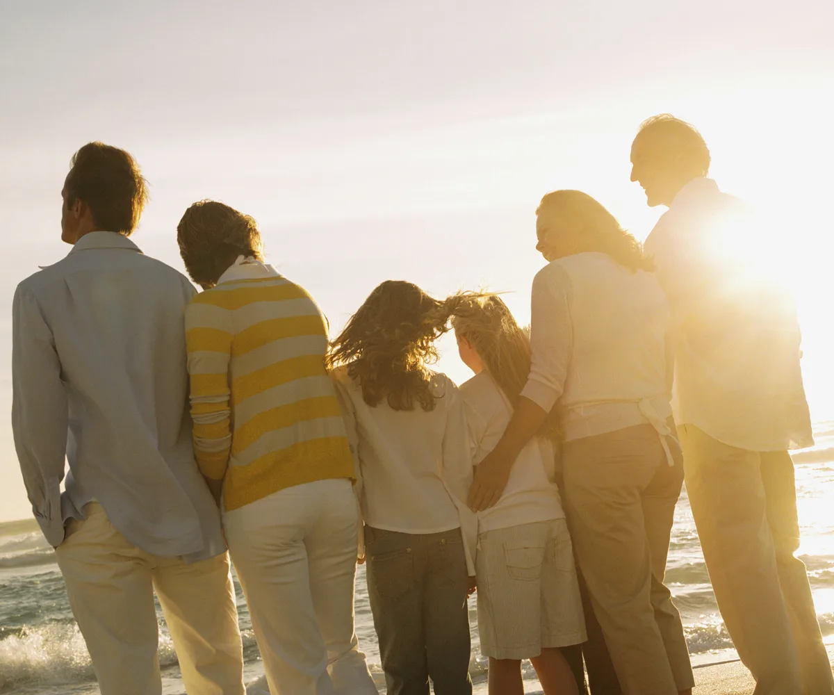 Family looking into horizon ocean sunset