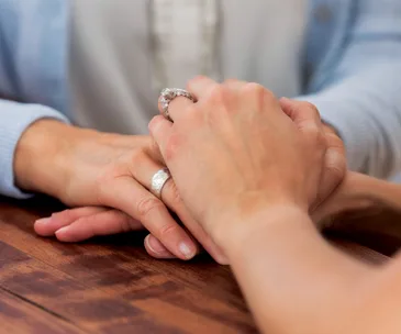 Close up of two hands holding each other