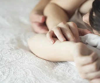 Woman and man cuddling in bed