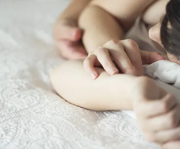 Woman and man cuddling in bed