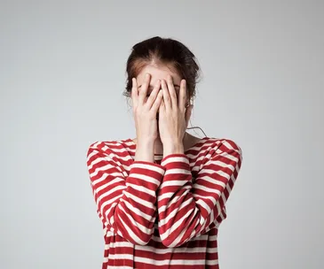woman with her head in her hands