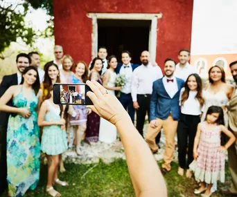 A wedding photographer has sparked heated debate after urging wedding guests to put away their phones