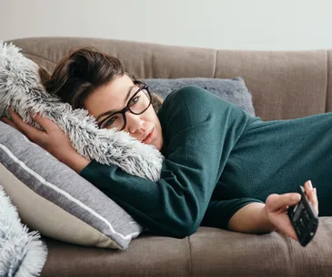 bored woman watching TV