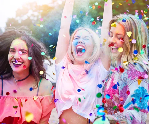 Group of three friends laughing confetti