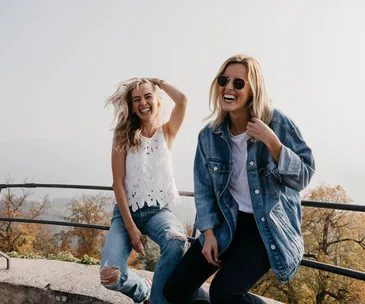 two women smiling in nature
