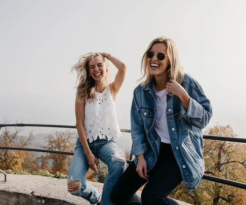 two women smiling in nature