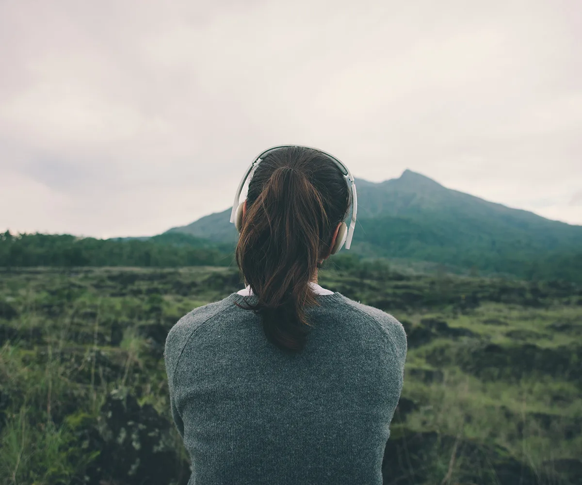 woman listening to music in nature