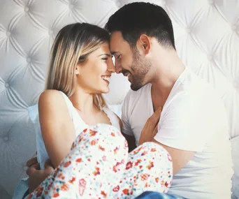 Couple cuddling in bed