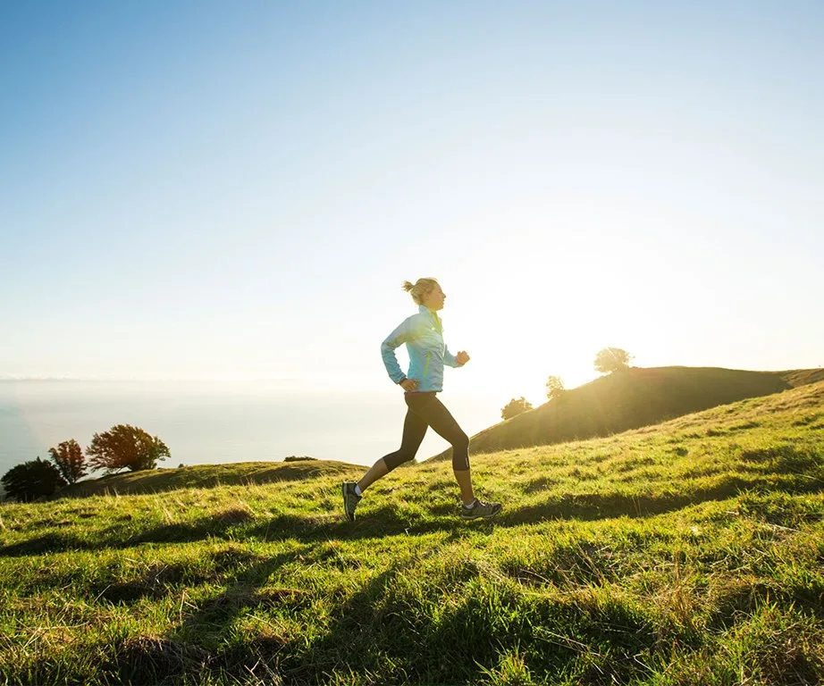woman running in the morning on a hill