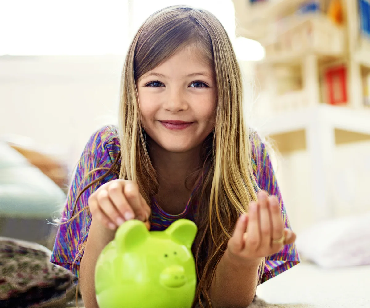 Young girl with piggy bank