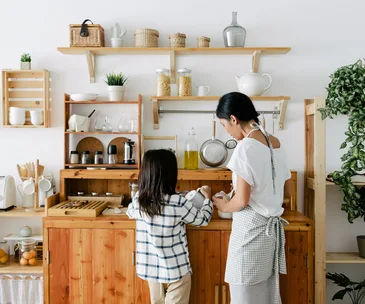 Mum and daughter baking in kitchen