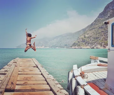  Woman Diving Into Sea From Pier 