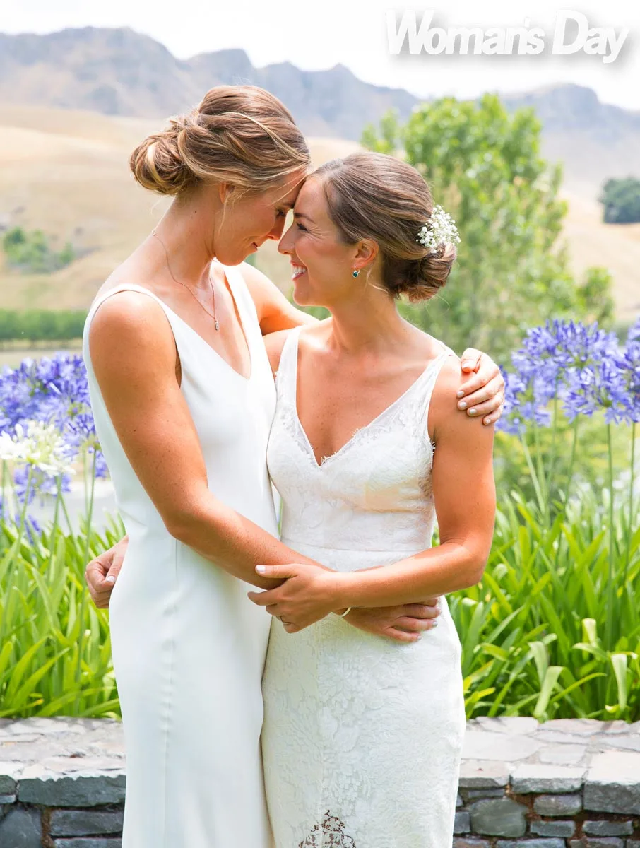 Emma hugging Charlotte in their bridal gowns