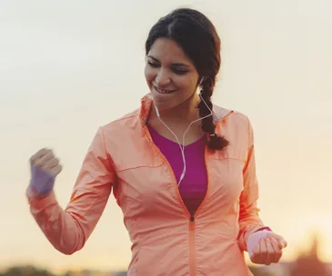 woman in exercise gear pumping fist in air
