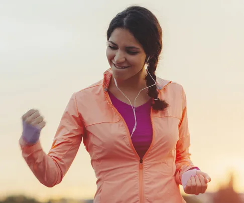 woman in exercise gear pumping fist in air