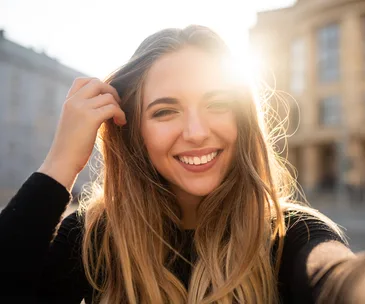 woman smiling hand through hair