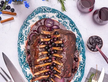 Roast racks of venison with blueberry balsamic sauce