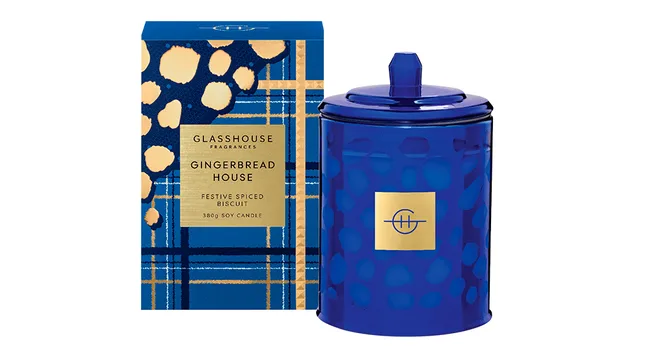 Blue Glasshouse Fragrances "Gingerbread House" candle box and jar with gold accents.