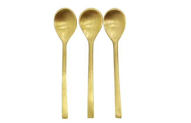 Three gold-colored metal spoons aligned side by side against a white background.