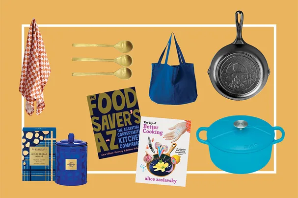 Various kitchen items on a yellow background, including books, pans, spoons, a towel, a bag, and a candle.
