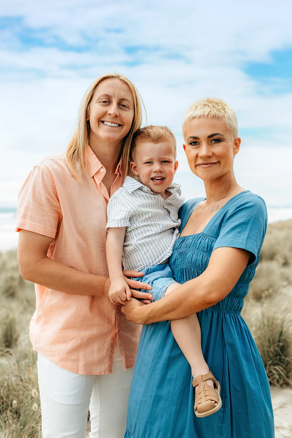 Kelly Brazier with partner Tahlia and son Oakley by the sand dunes