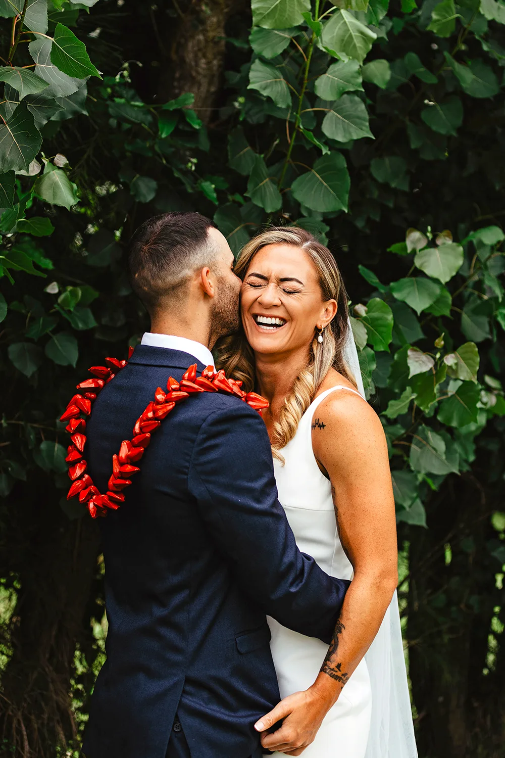 Niall and husband Tamāli'i hugging and laughing on their wedding day