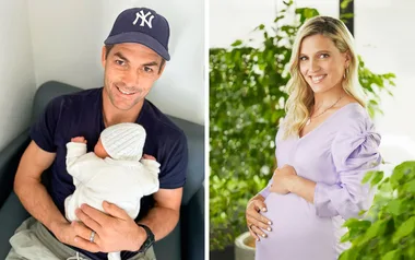 Man in a cap holding a baby on the left; woman in a lavender dress with a baby bump on the right.
