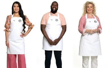 Three people wearing white aprons with the MasterChef logo, standing in a row on a plain white background.