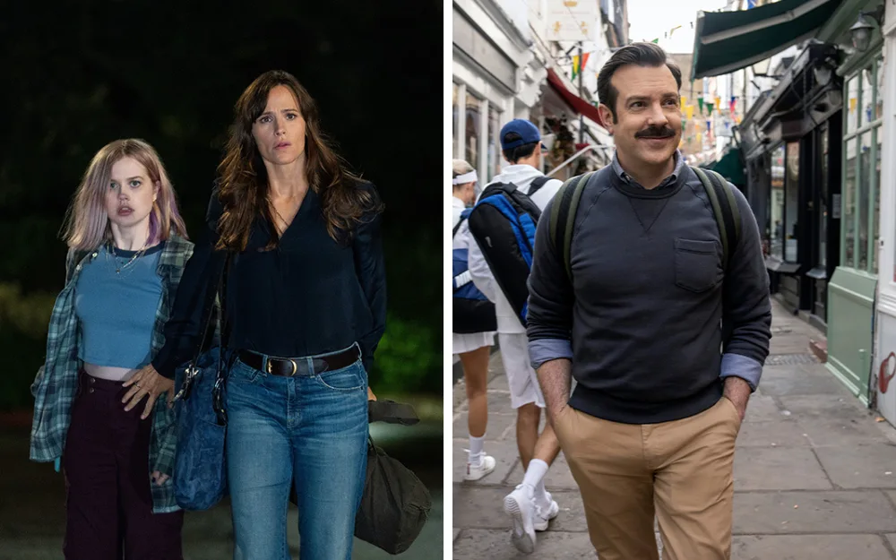 Two women walking at night on the left; a man with a mustache walking in a street on the right, smiling casually.
