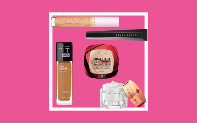 Various makeup products including concealers and foundations on a pink background.