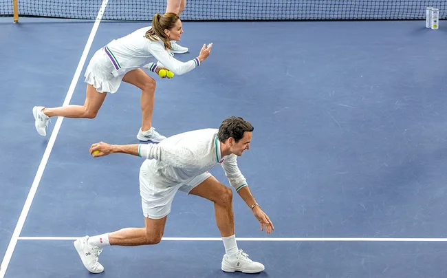 Tennis players in white outfits on a blue court, both preparing to serve a ball.