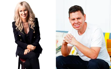 Two people seated: one with long blonde hair in a black outfit, the other with short brown hair in a white t-shirt.