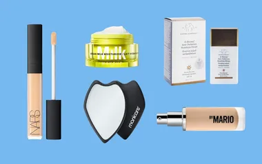 A selection of makeup products including NARS concealer, Milk moisturizer, Drunk Elephant drops, a mirror, and By Mario spray.
