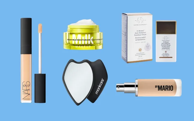 A selection of makeup products including NARS concealer, Milk moisturizer, Drunk Elephant drops, a mirror, and By Mario spray.