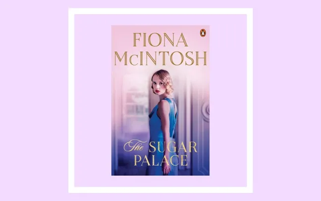 Fiona McIntosh's novel "The Sugar Palace" book cover with a woman in a blue dress, set against a soft pink background.