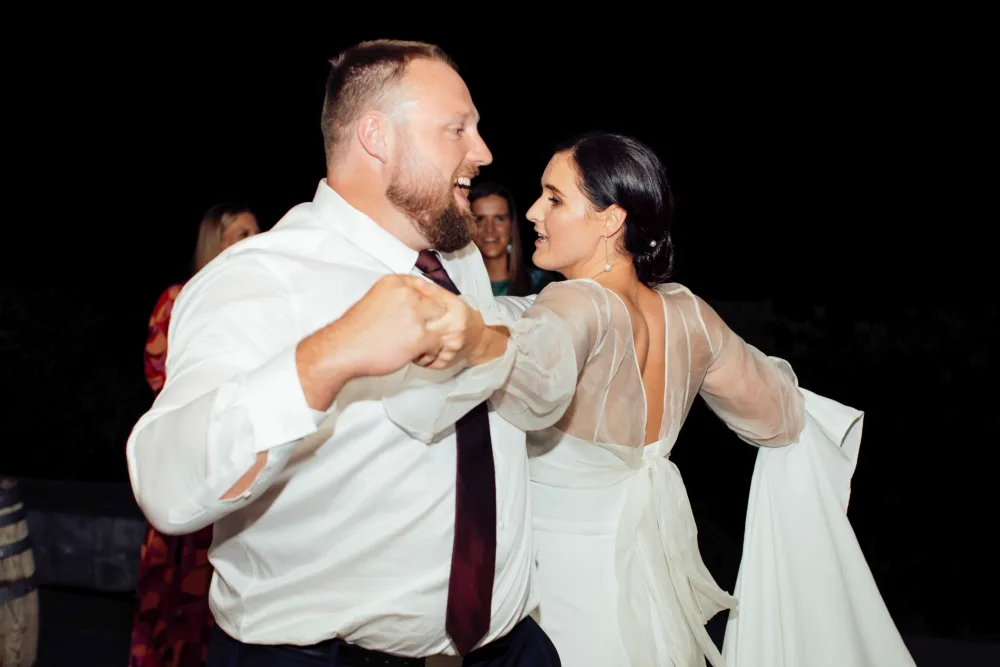 The bride and groom dancing into the night