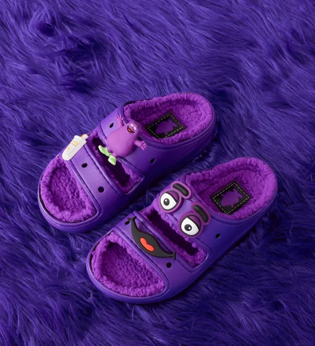 Purple furry slides with cartoon faces and character embellishments on a matching purple shaggy background.