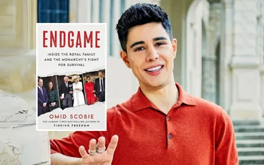 Man in red shirt next to a book titled "Endgame" by Omid Scobie about the royal family.