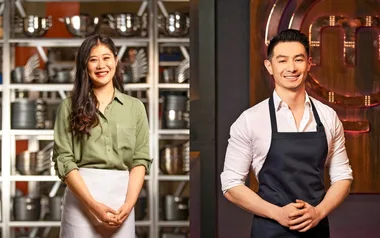 Two contestants from MasterChef Australia, a woman in a green shirt and apron, and a man in a white shirt and apron.
