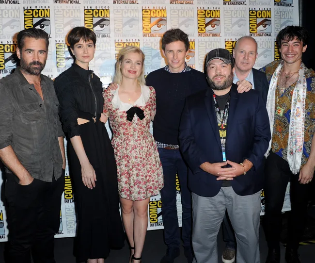 Group photo of seven people standing in front of a Comic-Con International backdrop.