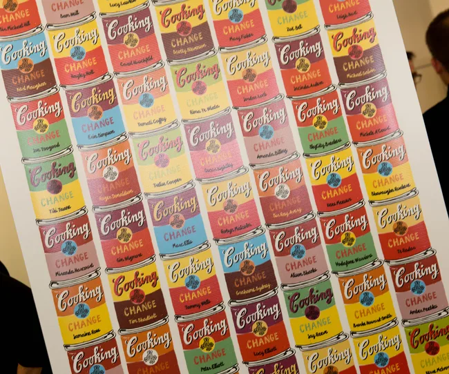 Colorful pop art poster featuring rows of cans labeled "Cooking Change" in various colors and designs.