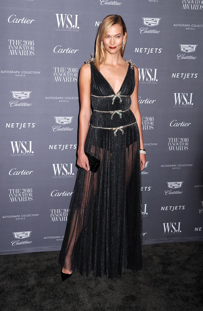 Woman in a black gown at the 2016 Innovator Awards, standing on a carpeted area with sponsor logos in the background.