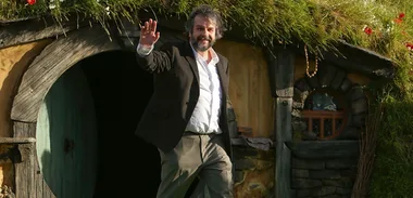 Peter Jackson emerges from a Hobbit house