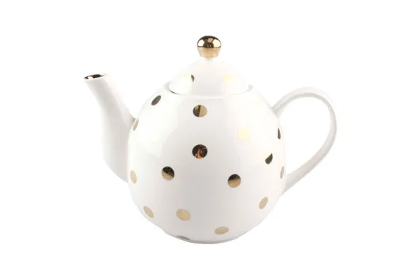 White teapot with gold polka dots and a gold-topped lid on a white background.