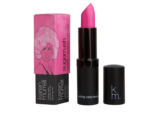 Pink Karen Murrell "Sugarrush" lipstick beside its illustrated box with a pop art design.