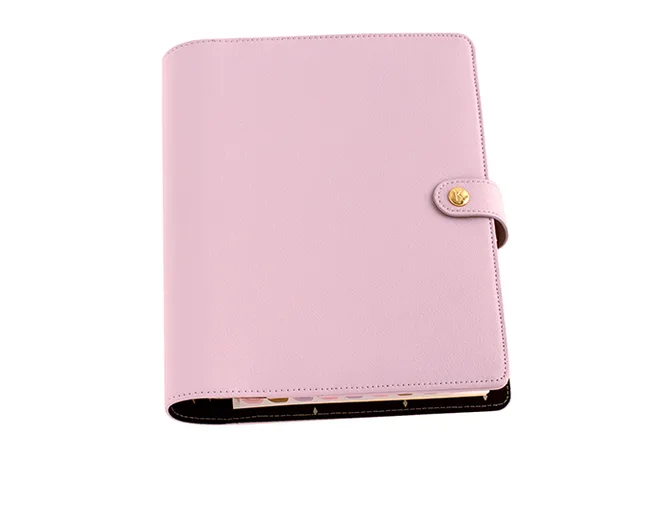 Pink leather planner with button closure and visible interior pages.