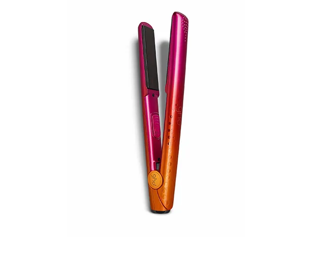 Pink and orange flat iron with black ceramic plates on a white background.