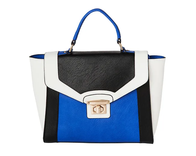 Color-block handbag with black, blue, and white panels, gold clasp, and blue handle.